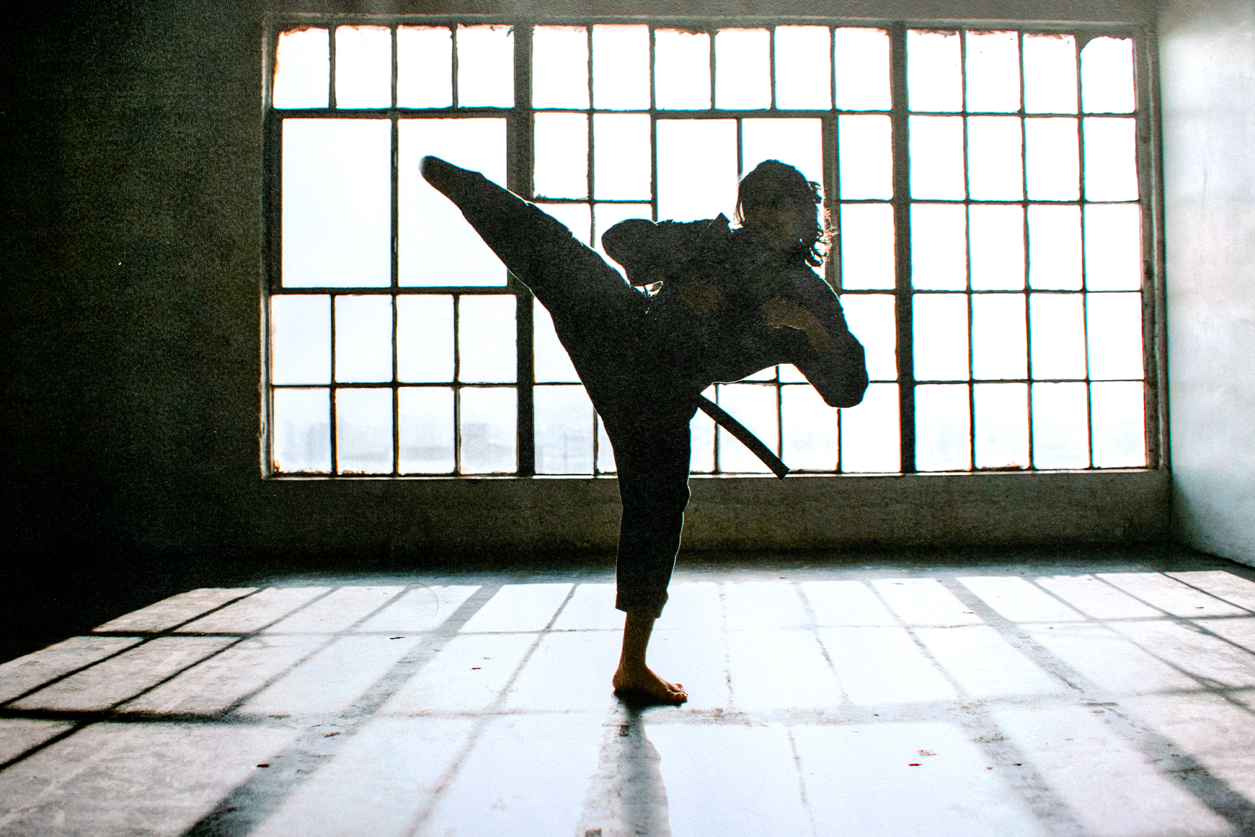 modified image of martial artist kicking at head height to depict amputation