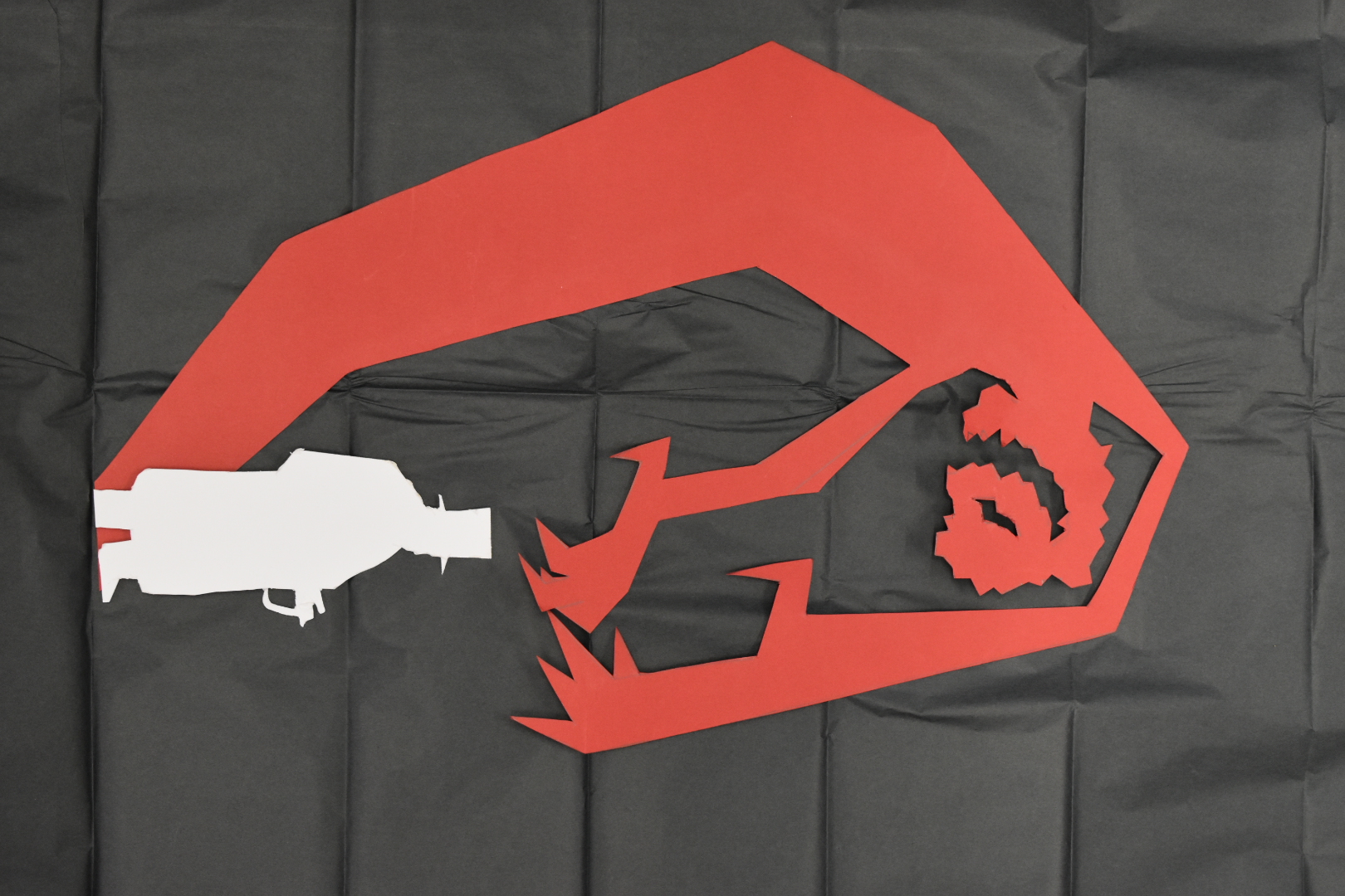 development of silhouette design cut from paper in white black and red
