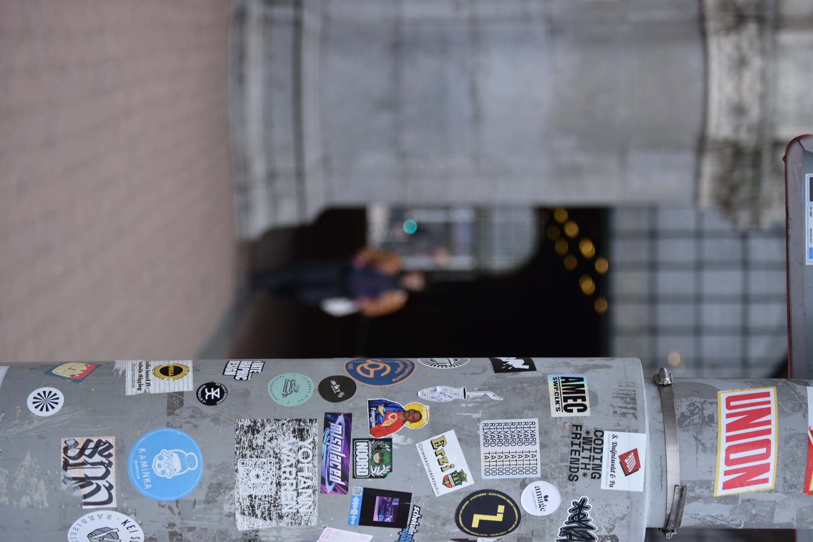 stickers covering metal lamppost in amsterdam