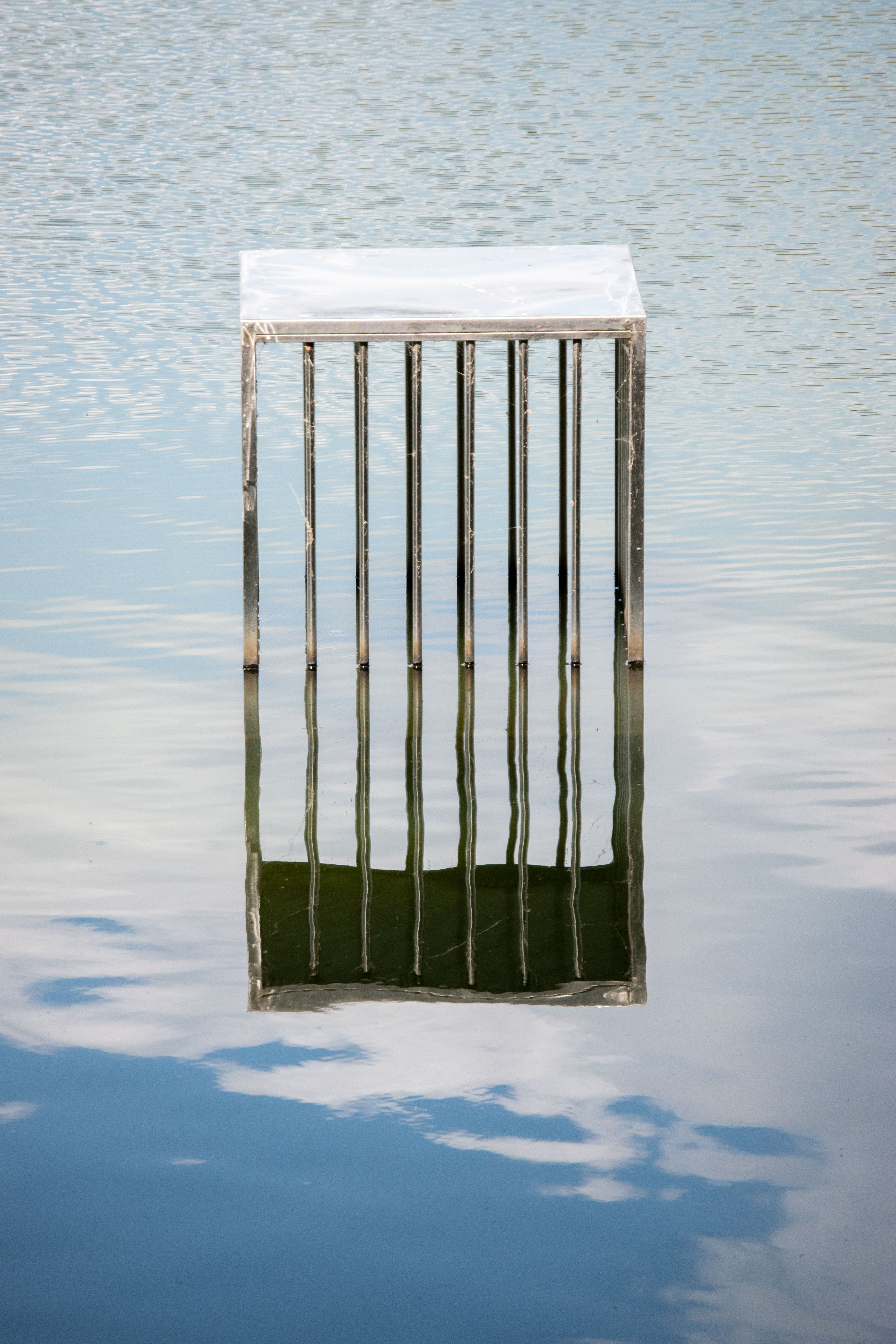 iron bars sculpture over water